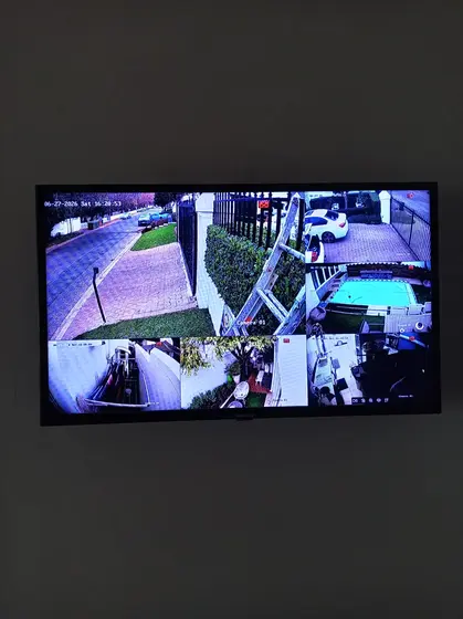 Eight-camera Hikvision system on a wall-mounted screen