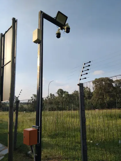 Pole-mounted camera on a perimeter fence line